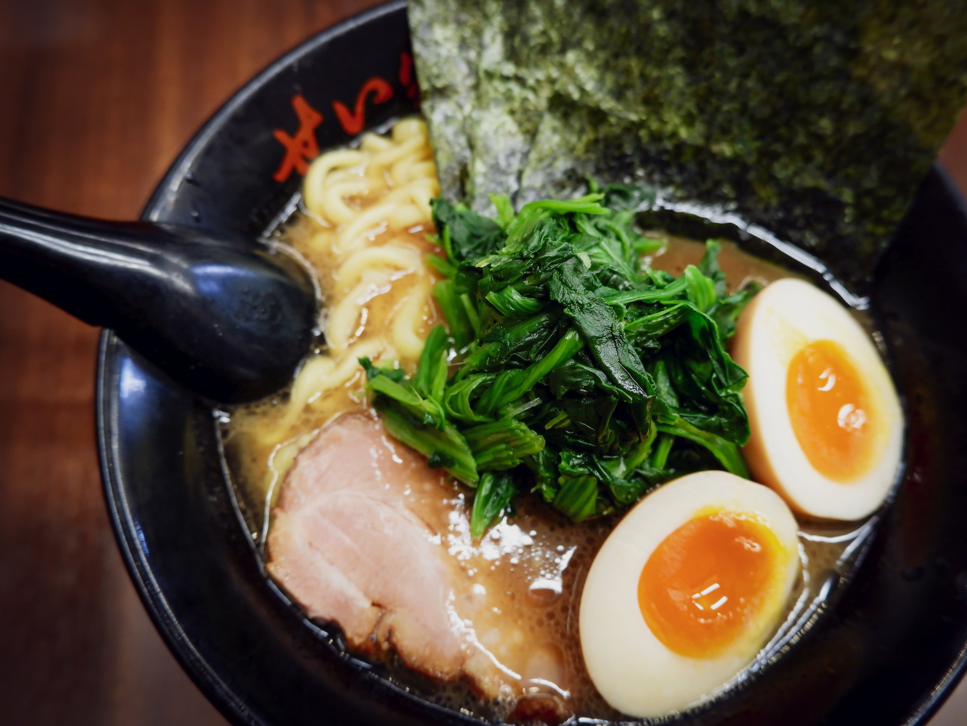 A Bowl of ramen with eggs, shashu and toppings